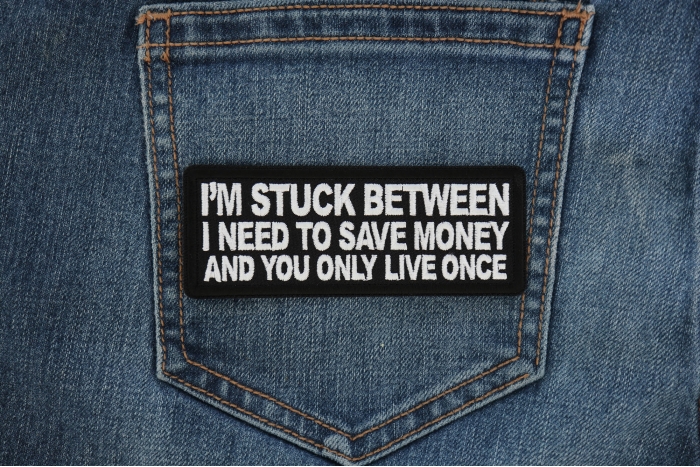 I'm stuck between I need to save money and you only live once Funny Iron on Patch shown on jeans