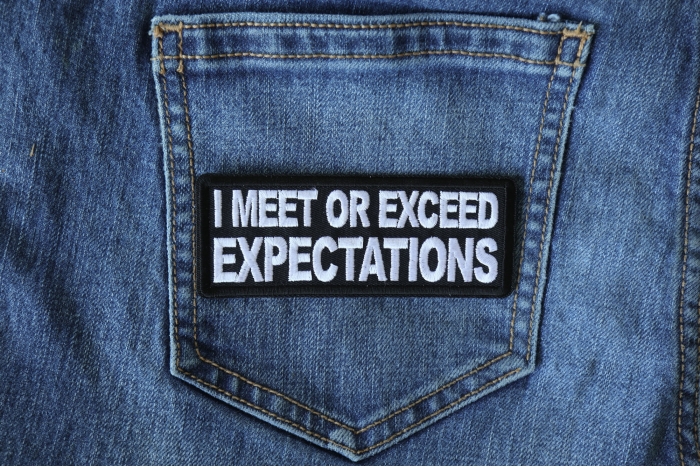 I Meet or Exceed Expectations Funny Iron on Patch shown on jeans