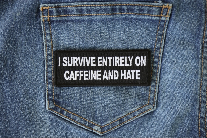 I survive entirely on Caffeine and Hate Funny Iron on Patch shown on jeans