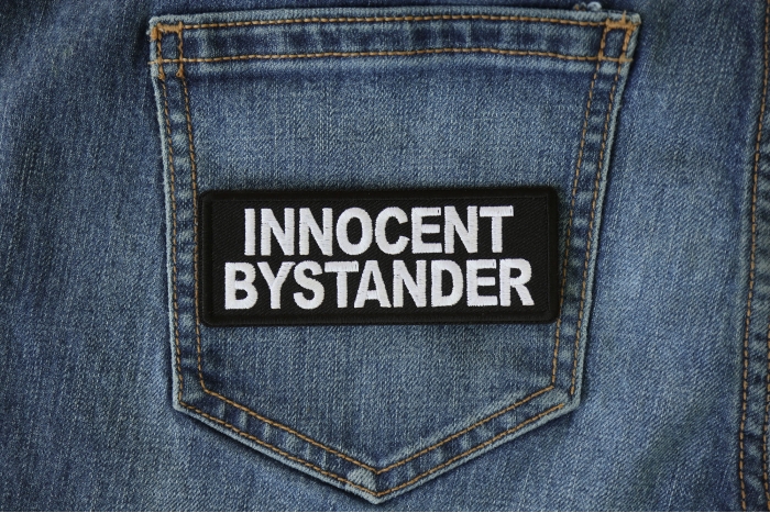 Innocent Bystander Funny Iron on Patch shown on jeans