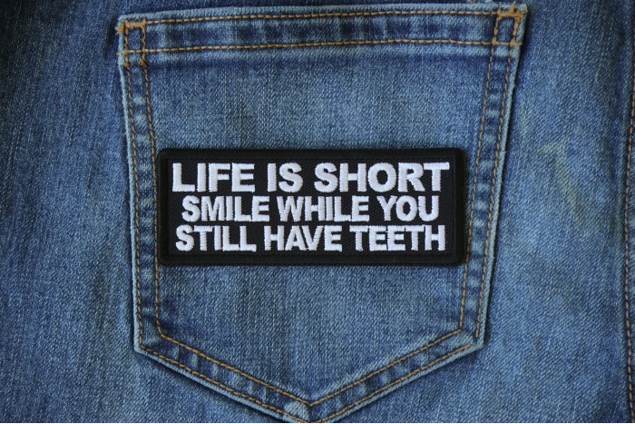 Life is Short Smile While You Still Have Teeth Patch shown on jeans
