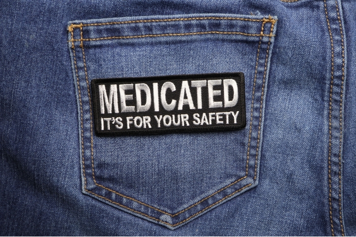 Medicated It's For Your Safety Patch shown on jeans