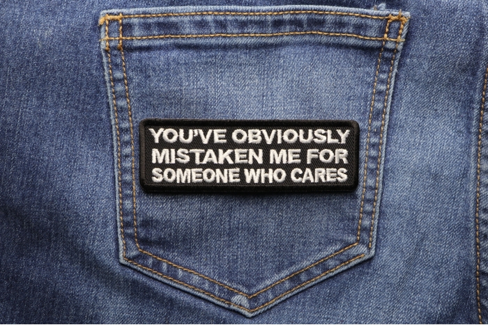 Mistaken Me For Someone Who Cares Funny Iron on Patch shown on jeans