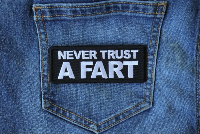 Never Trust a Fart Funny Iron on Patch shown on jeans