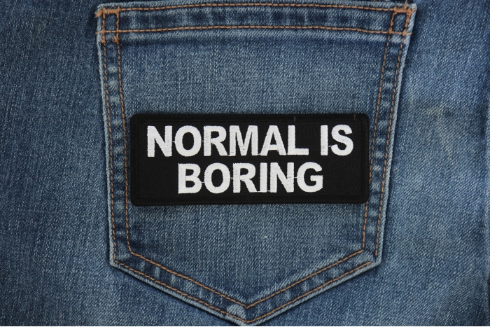 Normal is Boring Funny Iron on Patch shown on jeans