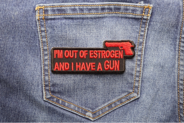 I'm Out Of Estrogen and I Have A Gun Funny Iron on Patch shown on jeans