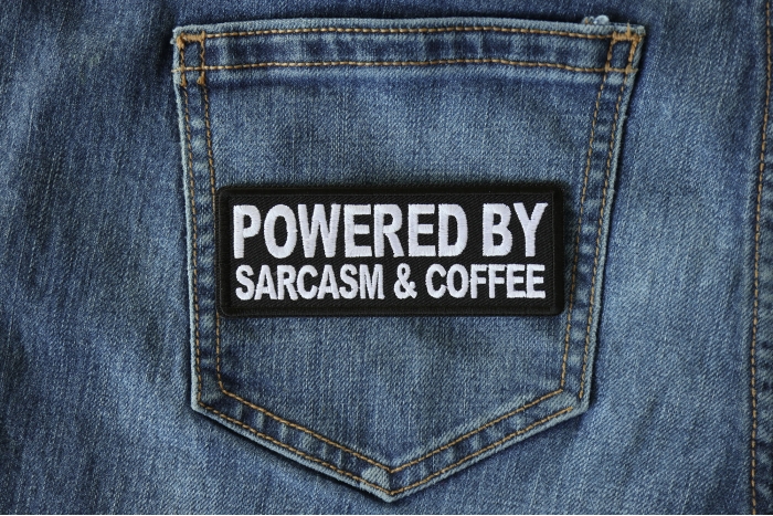 Powered By Sarcasm and Coffee Funny Iron on Patch shown on jeans