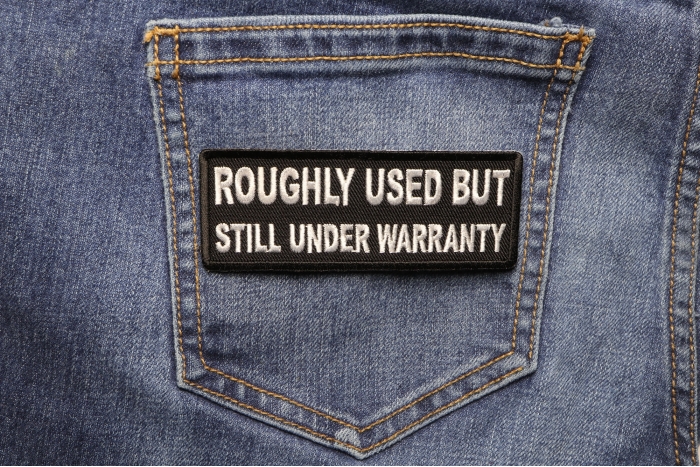 Roughly Used But Still Under Warranty Funny Iron on Patch shown on jeans