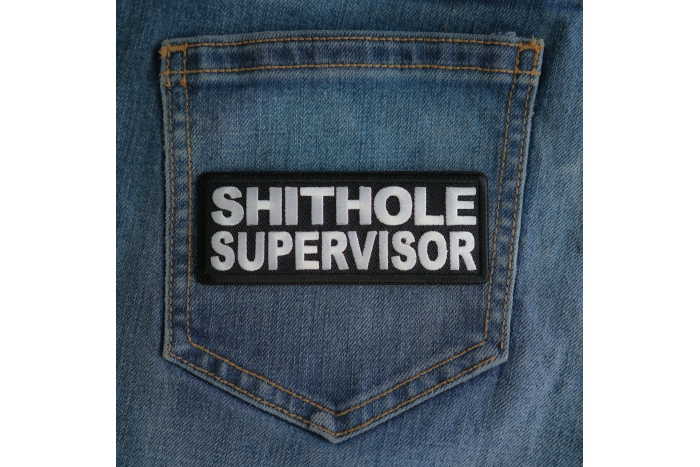 Shithole Supervisor Patch shown on jeans