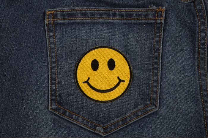 Smiley Patch 2.5 Inch Yellow shown on jeans