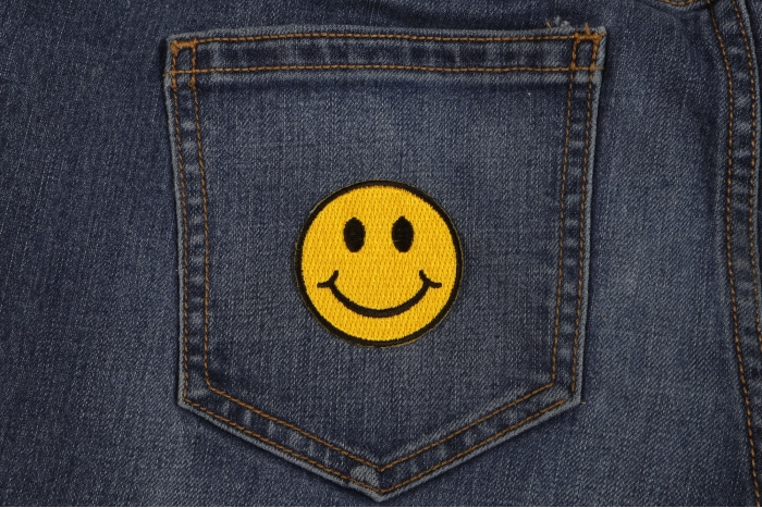 Smiley Patch 2 Inch Yellow shown on jeans