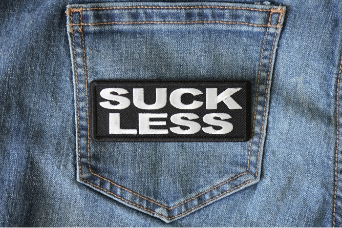 Suck Less Funny Iron on Patch shown on jeans