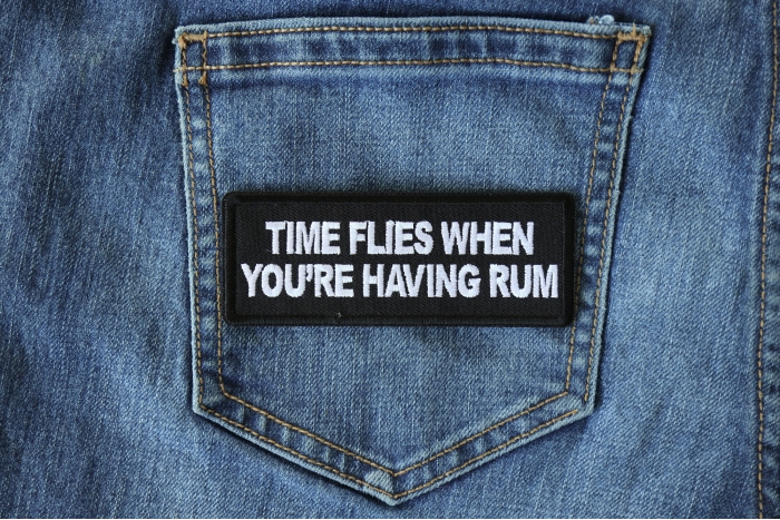 Time Flies when you are having Rum Funny Iron on Patch shown on jeans