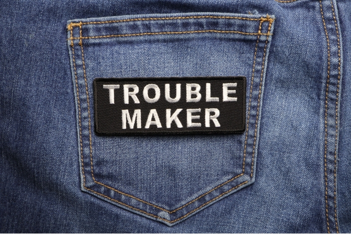 Trouble Maker Funny Iron on Patch shown on jeans
