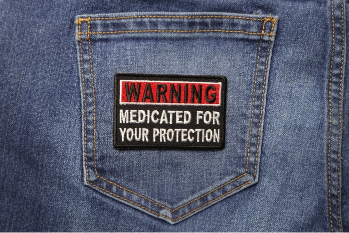 Warning Medicated For Your Protection Funny Iron on Patch shown on jeans