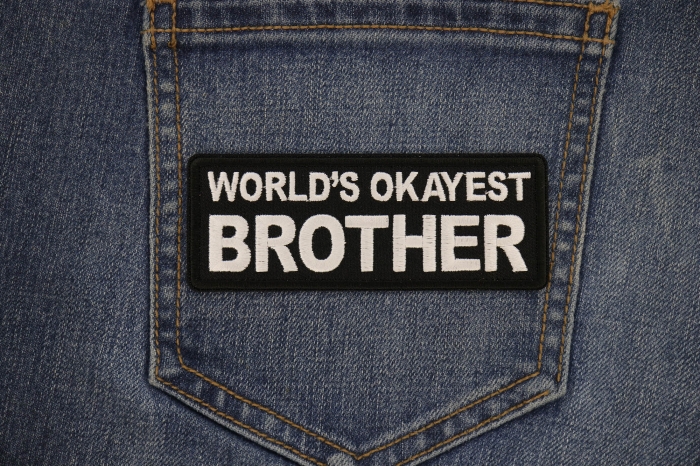 World's Okayest Brother Patch shown on jeans