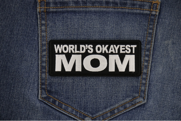 World's Okayest Mom Patch shown on jeans