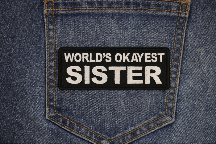World's Okayest Sister Patch shown on jeans