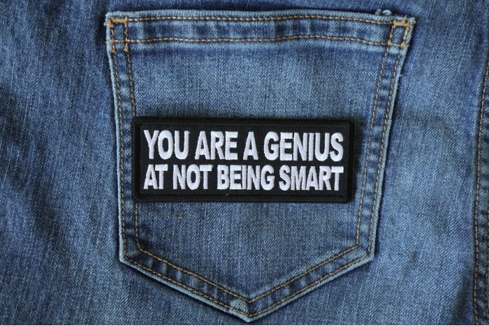 You are a Genius At Not Being Smart Funny Iron on Patch shown on jeans
