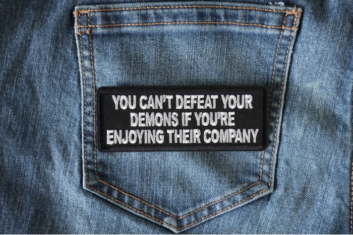 You Can't Defeat Your Demons If You're Enjoying Their Company Patch shown on jeans