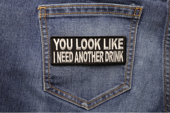 You Look Like I Need Another Drink Funny Iron on Patch shown on jeans