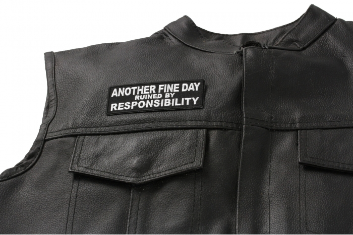 Another Fine Day Ruined By Responsibility Patch - 4x1.5 inch. Embroidered Iron on Patch shown on leather vest