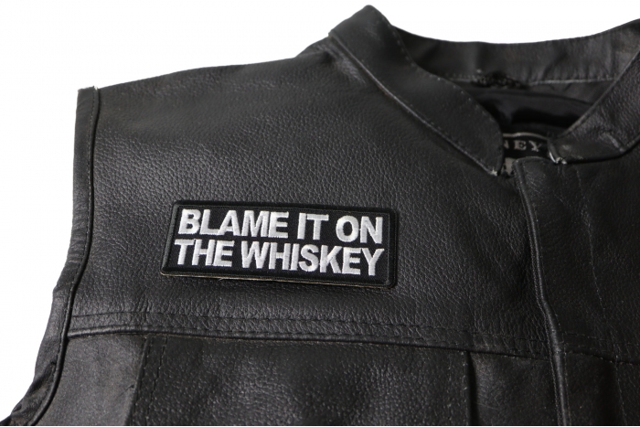 Blame it on The Whiskey Patch - 4x1.5 inch. Embroidered Iron on Patch shown on leather vest