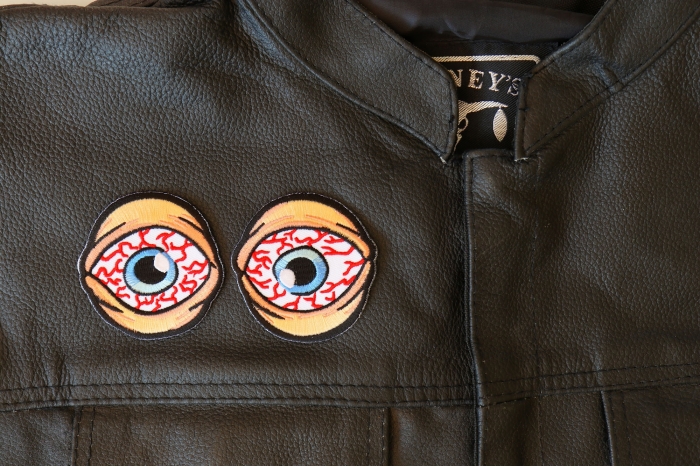 Bloodshot Eyes Patches - 2.5x2.5 inch - Embroidered Iron on Patch shown on leather vest
