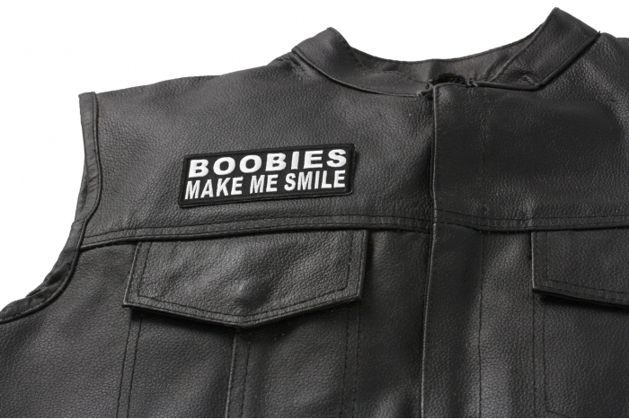 Boobies Make Me Smile Patch - 4x1.5 inch. Embroidered Iron on Patch shown on leather vest
