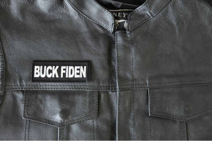 Buck Fiden Patch - 4x1.5 inch - Embroidered Iron on Patch shown on leather vest