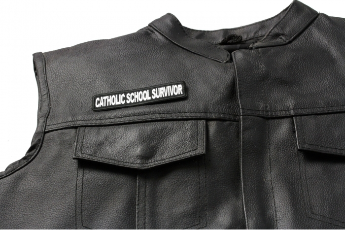 Catholic School Survivor Funny Christian Patch - 4x1 inch. Embroidered Iron on Patch shown on leather vest