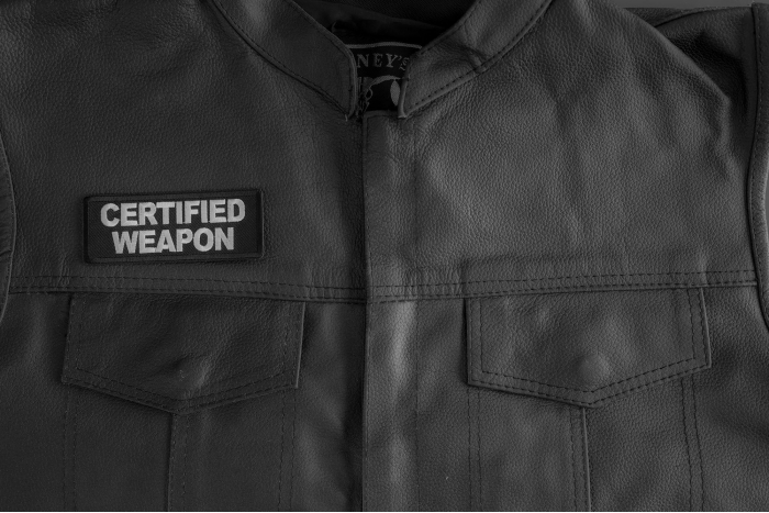 Certified Weapon Patch shown on leather vest
