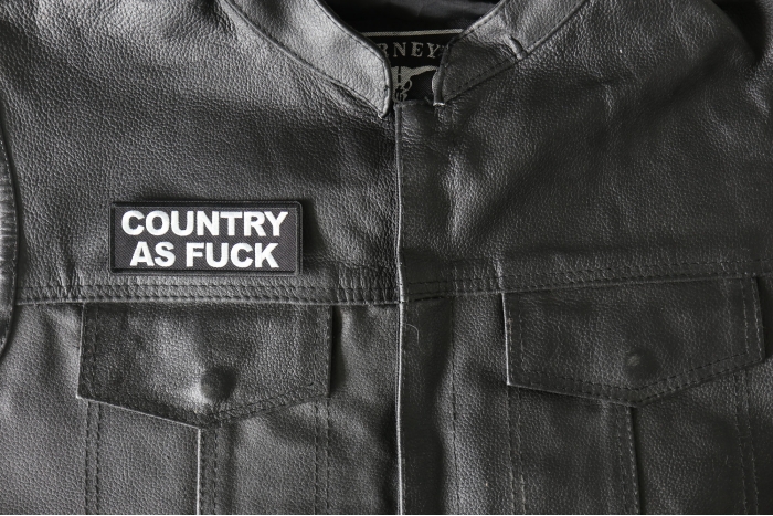 Country As Fuck Patch - 4x1.5 inch - Embroidered Iron on Patch shown on leather vest