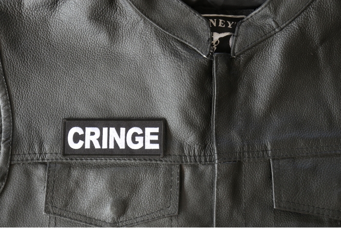 Cringe Patch - 4x1.5 inch - Embroidered Iron on Patch shown on leather vest