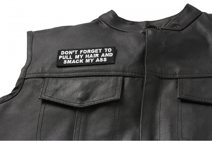 Don't Forget To Pull My Hair and Smack My Ass Patch - 4x1.5 inch. Embroidered Iron on Patch shown on leather vest