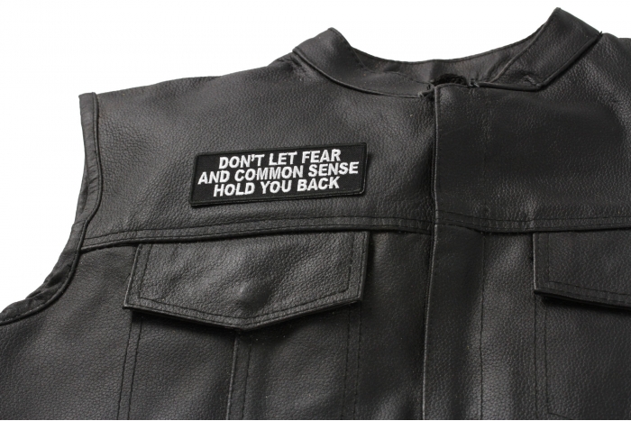 Don't Let Fear and Common Sense Hold You Back Patch - 4x1.5 inch. Embroidered Iron on Patch shown on leather vest