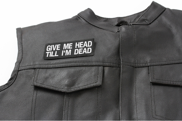 Give Me Head Till I'm Dead Patch - 4x1.75 inch. Embroidered Iron on Patch shown on leather vest