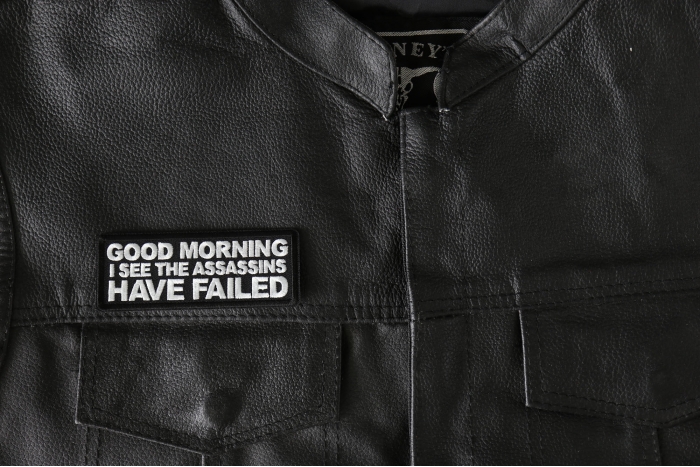 Good Morning I see the assassins have failed Patch - 4x1.5 inch - Embroidered Iron on Patch shown on leather vest