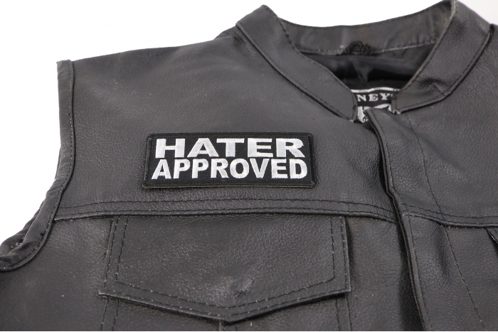 Hater Approved Patch - 4x1.5 inch. Embroidered Iron on Patch shown on leather vest