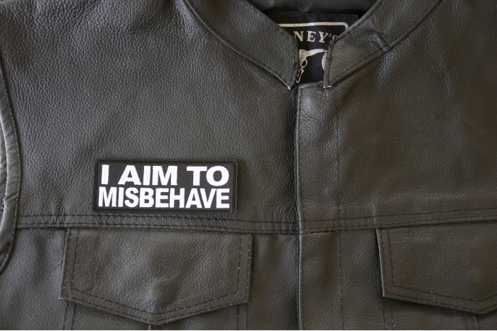 I aim to Misbehave Patch - 4x1.5 inch. Embroidered Iron on Patch shown on leather vest