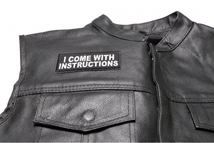 I Come with Instructions Patch - 4x1.5 inch. Embroidered Iron on Patch shown on leather vest