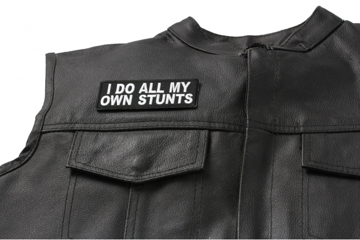 I Do All My Own Stunts Fun Patch - 4x1.5 inch. Embroidered Iron on Patch shown on leather vest