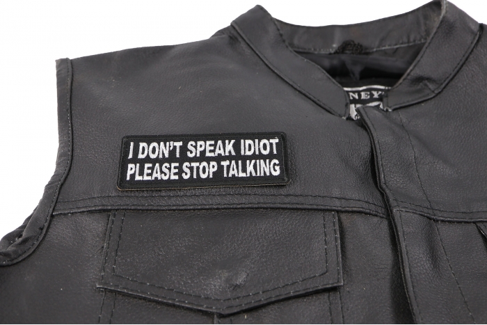 I Don't Speak Idiot Please Stop Talking Patch - 4x1.5 inch. Embroidered Iron on Patch shown on leather vest