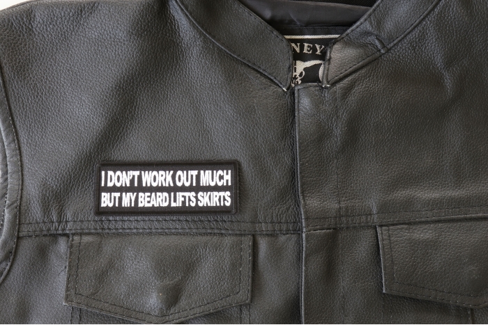 I Don't Work Out Much But My Beard Lifts Skirts Patch - 4x1.5 inch. Embroidered Iron on Patch shown on leather vest