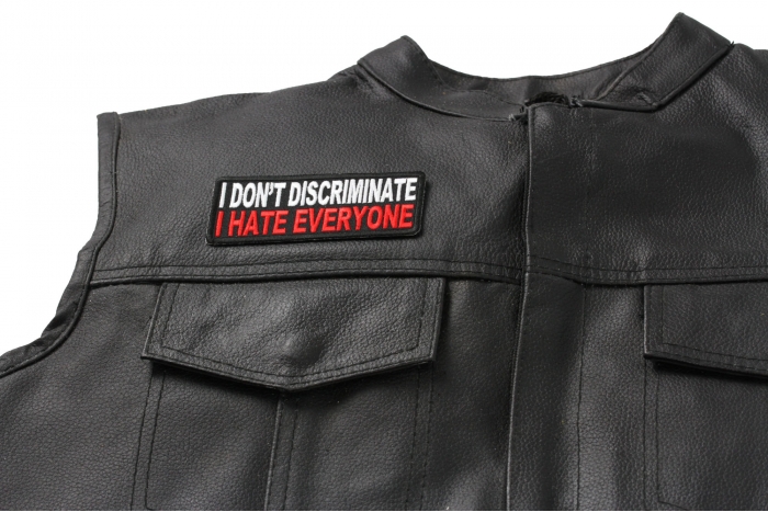 I Don't Discriminate I Hate Everyone Patch - 4x1.5 inch. Embroidered Iron on Patch shown on leather vest