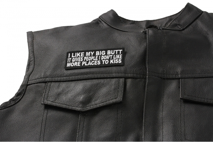 I Like My Big Butt Gives People Places To Kiss Patch - 4x1.5 inch. Embroidered Iron on Patch shown on leather vest