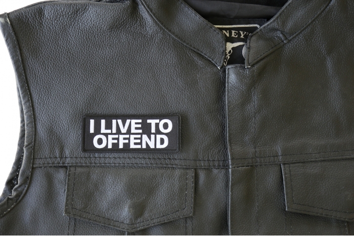 I Live to Offend Patch - 4x1.5 inch. Embroidered Iron on Patch shown on leather vest