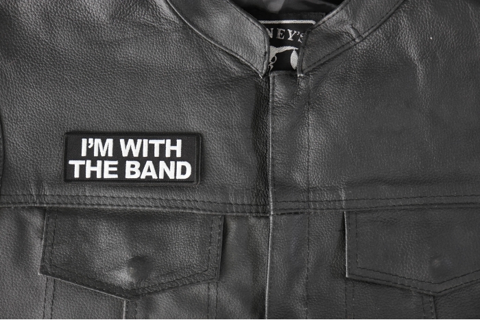 I'm with the Band Patch - 4x1.5 inch - Embroidered Iron on Patch shown on leather vest