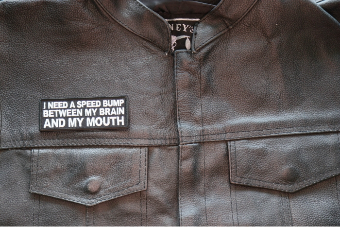 I need a Speed Bump between my Brain and my Mouth Patch, Funny Saying Patches shown on leather vest