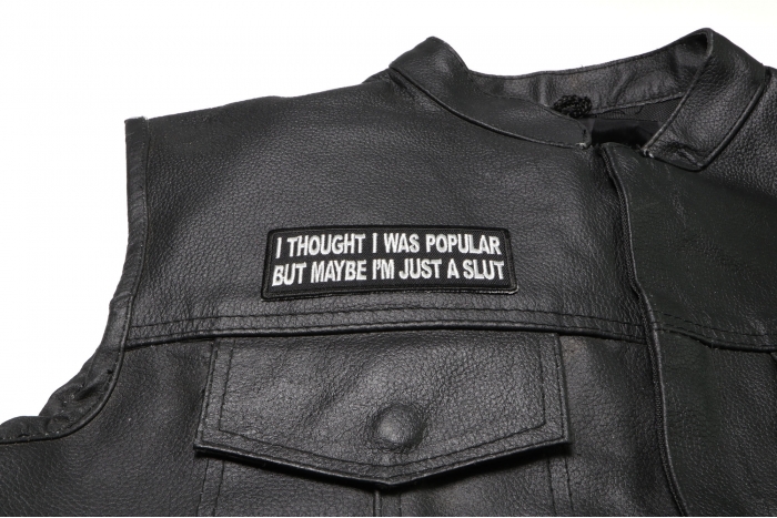 I Thought I was Popular But Maybe I'm Just a Slut Patch - 4x1.5 inch. Embroidered Iron on Patch shown on leather vest